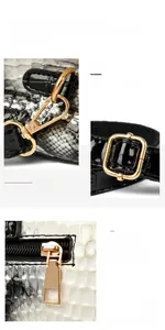 Detail of snake skin pattern texture and polished gold hardware on a stylish handbag