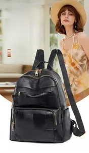 Detail of waterproof black faux leather backpack with gold zippers and stitched patterns