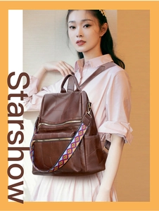 Detail of dark brown leather backpack with colorful geometric woven shoulder strap