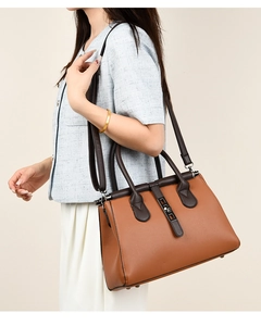 Caramel brown pebbled leather handbag with adjustable strap shown on model for daily commute