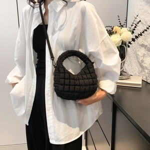 Chic black quilted puffy mini tote bag with adjustable shoulder strap for women
