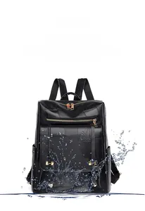 Close-up of waterproof black faux leather backpack showing durable splashproof material