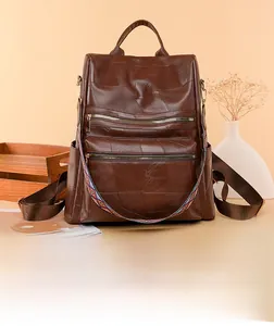 Detail of soft leather backpack featuring retro patchwork texture and colorful ethnic strap