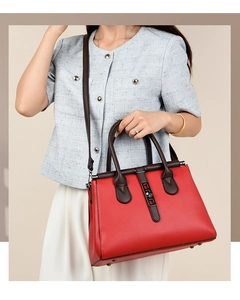 Lifestyle view of a vintage red leather handbag with top handle and crossbody strap