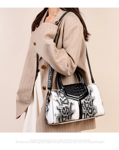 Detail of snake and crocodile texture patchwork on a stylish women's crossbody handbag