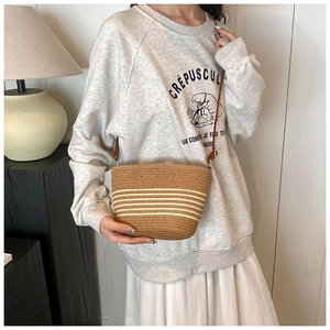 Handwoven straw crossbody bag with brown and white stripes for summer beach vacation