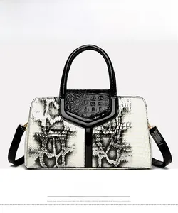 Close-up of black and white snakeskin pattern handbag with polished finish and handles