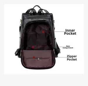 Detail view of the black leather backpack's interior pockets and brown lining structure