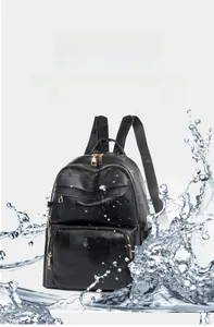 Detail of waterproof black faux leather backpack with water splashing on the surface