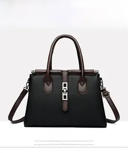 Front view of black pebble leather tote with brown straps and silver metal buckle