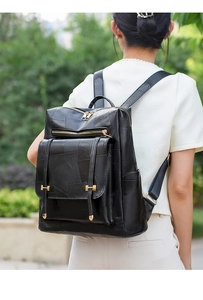 Detailed view of black faux leather backpack featuring geometric textured patchwork design