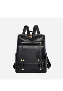 Detailed view of black women's backpack with gold zippers and textured faux leather finish