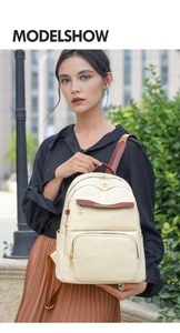 Close-up of cream white leather backpack featuring gold hardware and geometric textures