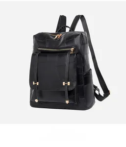 Detailed side view of black leather backpack featuring gold H-hardware and zipper textures