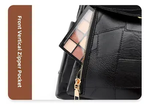 Détail de la poche zippée verticale à l'avant du sac à dos en cuir noir patchwork