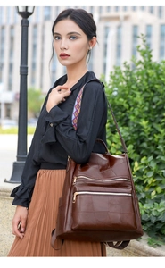 Detail of dark brown faux leather backpack with geometric colorful woven shoulder strap