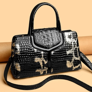 Elegant black snakeskin embossed handbag with gold accents and detachable shoulder strap