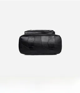 Detail view of the durable black leather backpack base with premium quilted stitching