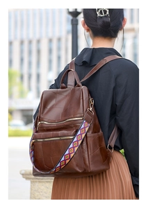 Detail of soft leather backpack with ethnic geometric strap and multi-zipper pockets