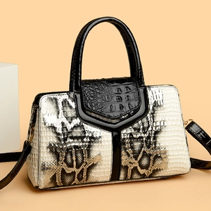 Elegant snakeskin pattern handbag with monochrome patchwork and top handle