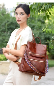 Close-up of brown vintage leather backpack with unique ethnic geometric woven strap