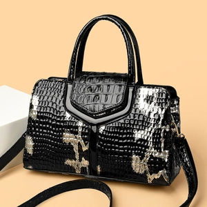 Elegant snakeskin patterned faux leather handbag with silver accents and top handle