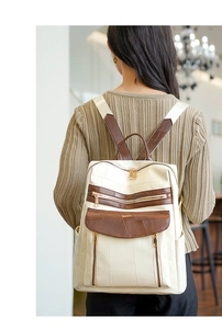 Détail du sac à dos vintage bicolore à grande capacité avec fermetures éclair dorées