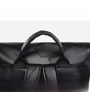 Close-up of durable black faux leather backpack featuring reinforced carry handle