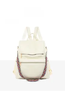 Front view of creamy white leather backpack with geometric stitching and ethnic strap
