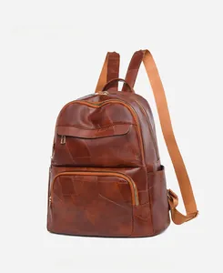 Detail of brown oxford print backpack featuring vintage leather texture and side pockets