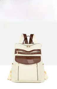 Vue détaillée du sac à dos rétro blanc cassé avec patchwork marron et fermetures éclair
