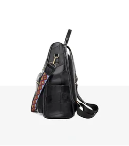 Detail of the multi-textured black leather patchwork backpack with gold-tone hardware