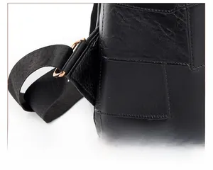 Macro view of shoulder strap connection with reinforced stitching and rose gold hardware