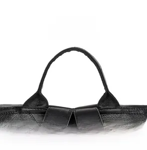Close-up of durable black soft leather top handle with reinforced stitching and grain texture