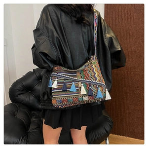 Bohemian canvas shoulder bag with colorful geometric patterns and blue tassels