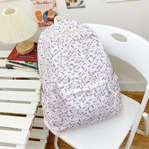 Floral canvas backpack in white with purple flower prints for a fresh casual style