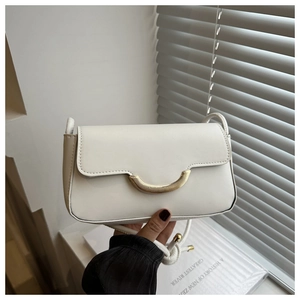 Detail of white leather shoulder bag with crescent gold buckle and slim strap