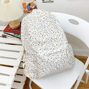 Floral print cream backpack for women in a cozy minimalist interior setting