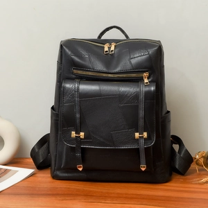Minimalist black leather backpack with gold zippers and large capacity compartments