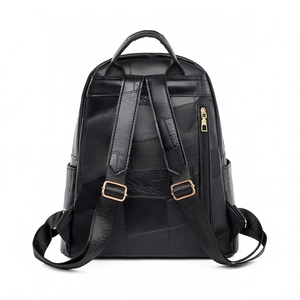 Back view of black pebble leather backpack with gold hardware and fabric straps