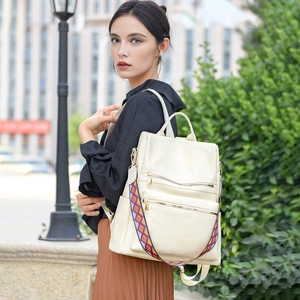 Chic beige soft faux leather backpack with woven ethnic strap for casual outdoor use