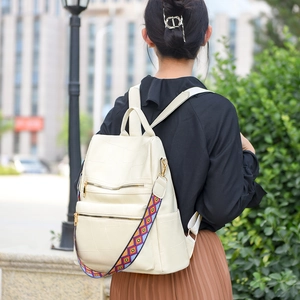 Cream white vintage leather anti-theft backpack with patterned strap and gold zippers