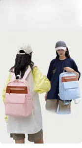 Dual carrying options showing backpack straps and handheld handle in pink and blue