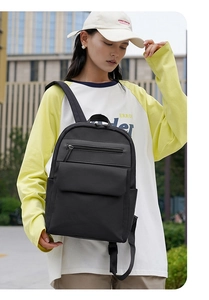 Outdoor view of a black oxford backpack showing side pockets and large capacity