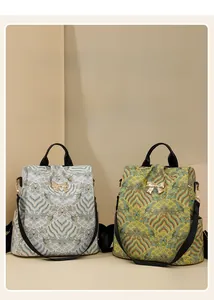 Detail of vintage pattern backpacks in beige and yellow with gold bow buckle and side pockets