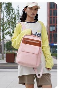 Pink and brown waterproof nylon backpack with multi-pocket storage and zip closure