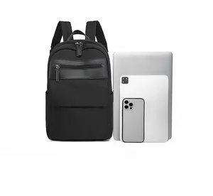 Practical size comparison of black nylon backpack next to laptop and tablet devices
