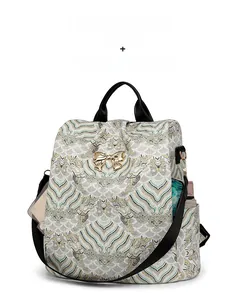 Detail view of large-capacity golden jacquard backpack with side pocket and metallic bow