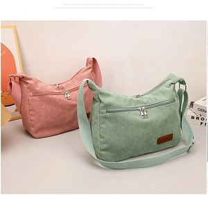 Pink and green corduroy crossbody bags with dual zippers and adjustable straps