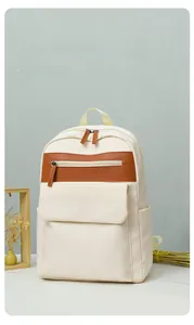 Cream oxford fabric backpack with brown leather trim and side water bottle pocket